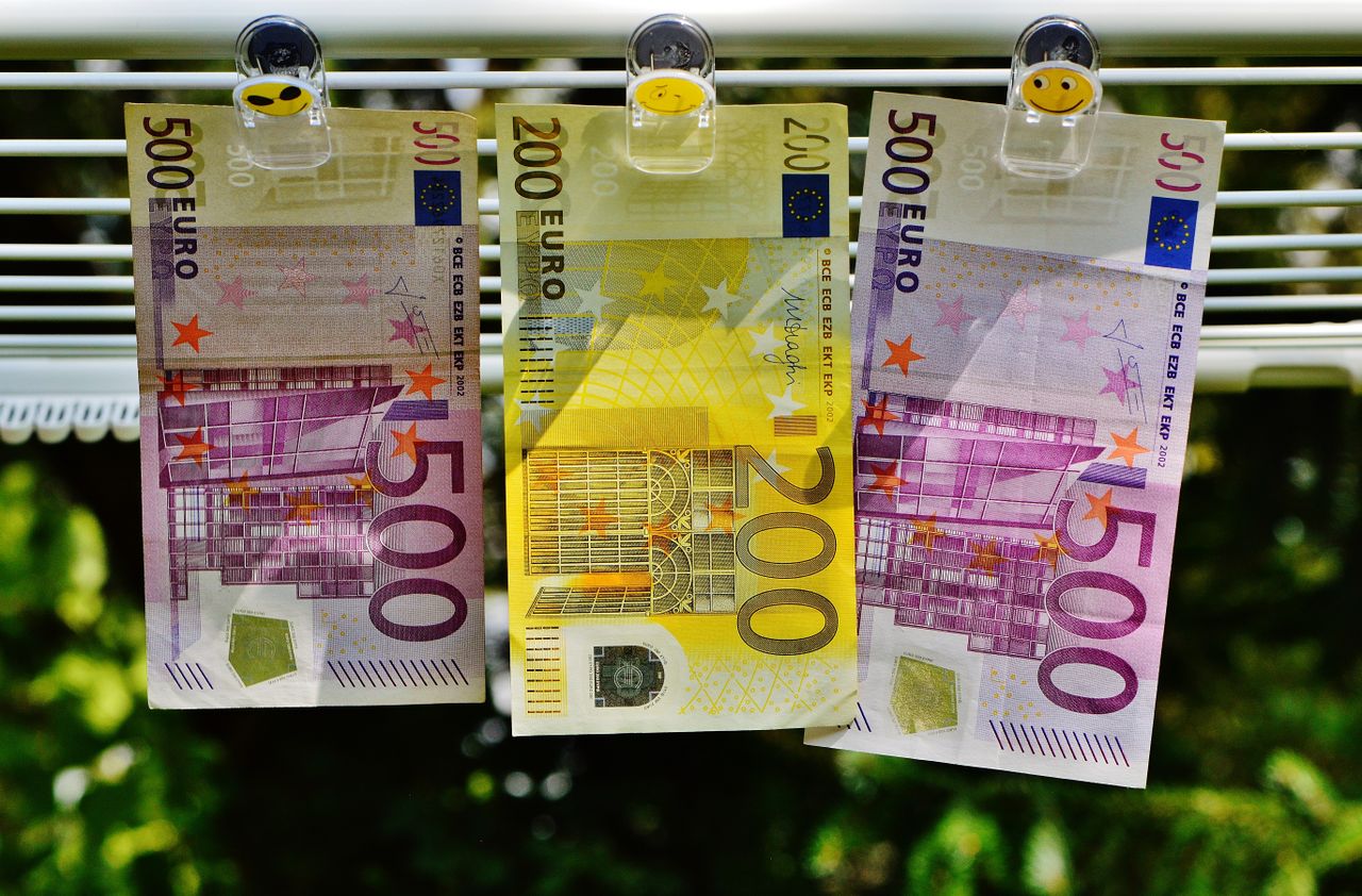 Services Euro currency notes clipped to a line, symbolizing finance concepts like money laundering or savings.