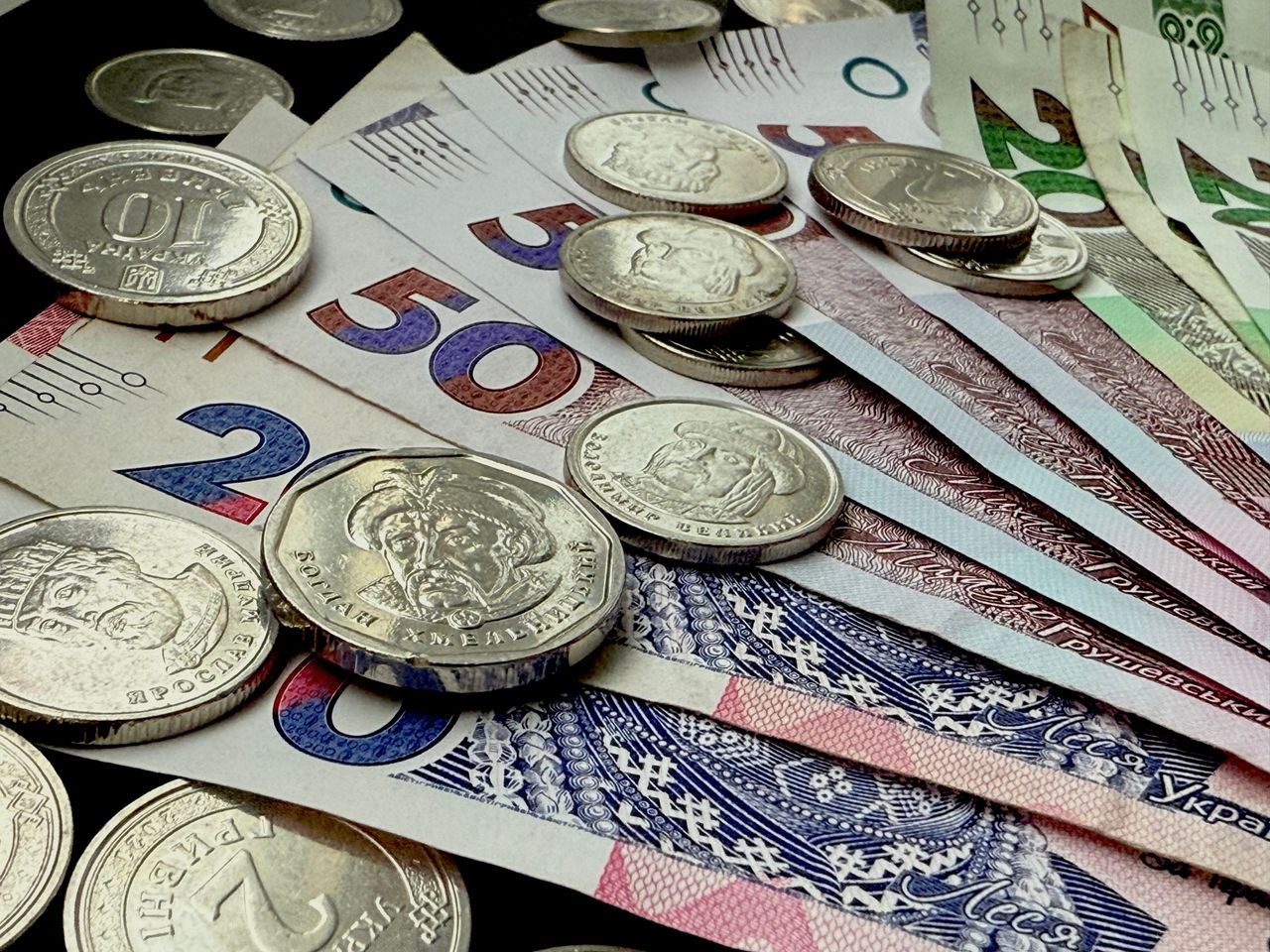 Hello world! Close-up of various coins and banknotes from different countries, showcasing diversity in currency.